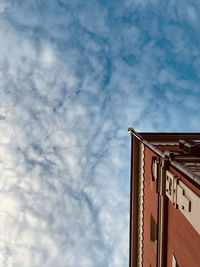 Low angle view of building against cloudy sky