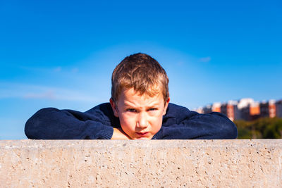 Portrait of boy against blue sky