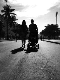 Woman walking on road against sky