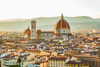 High angle view of florence cathedral in city during sunset