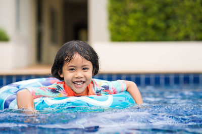 Little adorable girl have fun at outdoor swimming pool