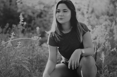 Young woman sitting on field