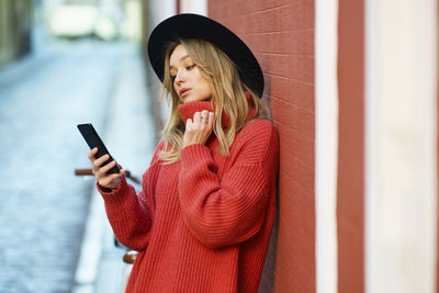 Young woman using mobile phone outdoors