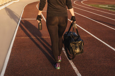 Low section of man walking on the road