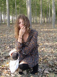 Portrait of woman sitting in forest