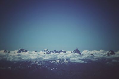 Scenic view of snowcapped mountains against clear blue sky