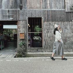 Full length of young woman walking on street