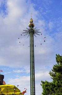 Low angle view of chain swing ride against sky