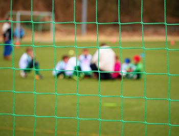 People playing soccer on field