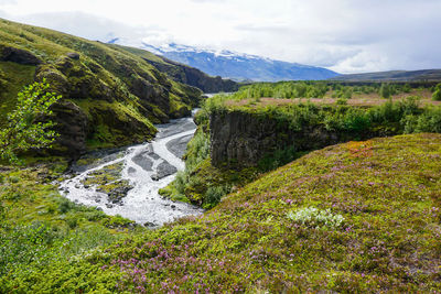 Scenic view of waterfall against sky