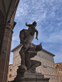 Low angle view of statue against sky