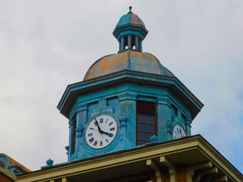 Low angle view of clock tower against sky