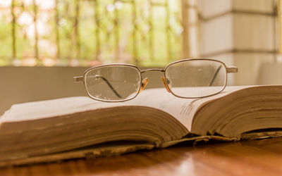 Close-up of eyeglasses on book on table