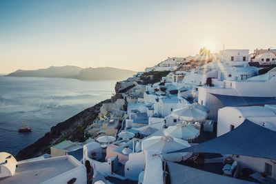 High angle view of town by sea against sky