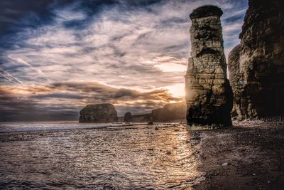 Scenic view of sea against dramatic sky