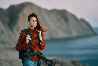 Portrait of smiling young woman standing outdoors