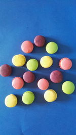 Multi colored candies against blue background