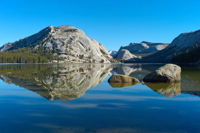 Reflection of mountains in lake against blue sky