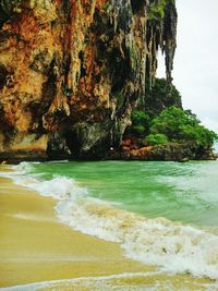 Scenic view of rock formation in sea against sky