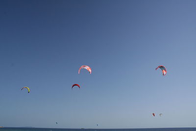 Low angle view of kites against sky