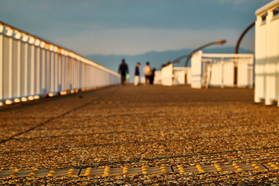 People walking on road against sky