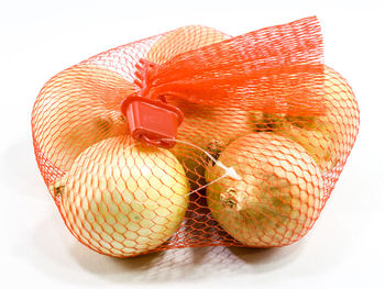 High angle view of orange fruit against white background