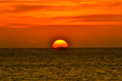 Scenic view of sea against romantic sky at sunset