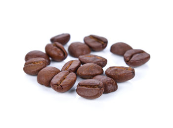 Close-up of coffee beans against white background