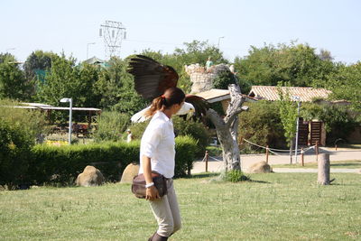 Full length rear view of woman on field