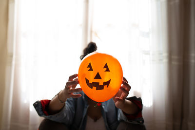 Full length of a man holding pumpkin