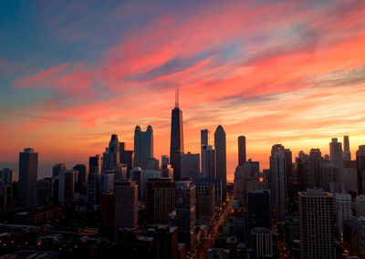 Modern buildings in city during sunset