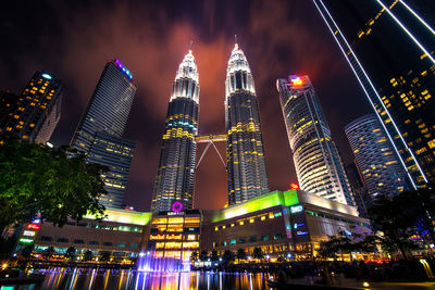 Low angle view of illuminated buildings against sky at night