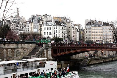 Buildings and bridge against sky