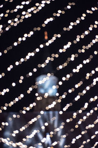 Low angle view of illuminated lights at night