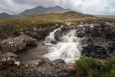 Beautiful sligachan waterfalls on the isle of skye, the cuillin mountains rising behind