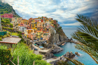 High angle view of townscape by sea against sky