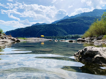 Scenic view of sea and mountains against sky