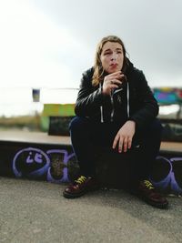 Full length of boy sitting outdoors