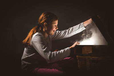 Side view of girl playing at home