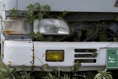 Close-up of abandoned truck on field