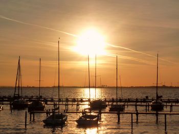 Sailboat in sea at sunset