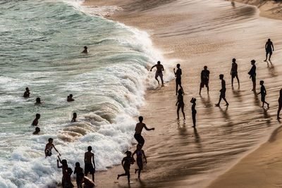 Large group of people on paciencia beach in the rio vermelho neighborhood of salvador, brazil. 