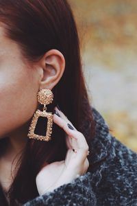 Close-up of young woman wearing earring