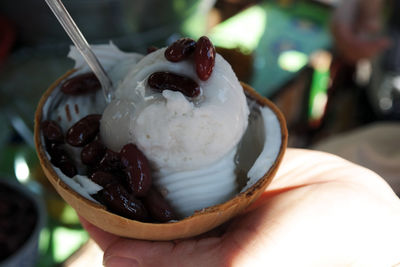 Close-up of hand holding ice cream