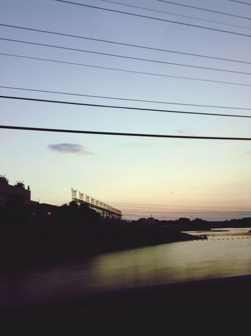 sunset, silhouette, sky, power line, water, built structure, architecture, connection, dusk, nature, building exterior, electricity pylon, cable, scenics, tranquility, outdoors, no people, tranquil scene, beauty in nature, reflection