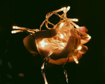 Close-up of illuminated christmas lights against black background