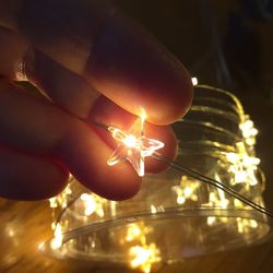 Close-up of hand holding illuminated light bulb