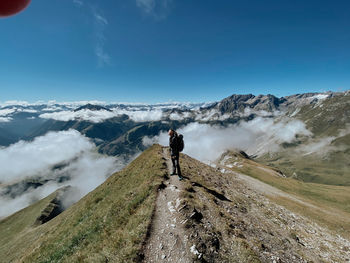 Man standing on mountain against sky