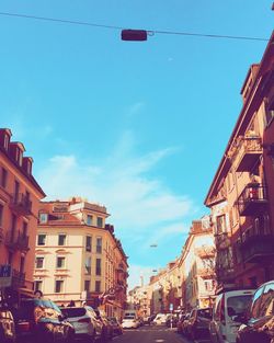 Buildings in city against blue sky