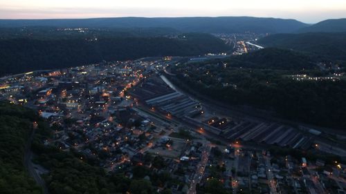 High angle view of illuminated road amidst buildings in city